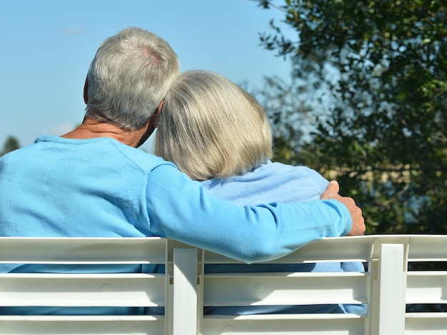 senior woman and man sitting on bench