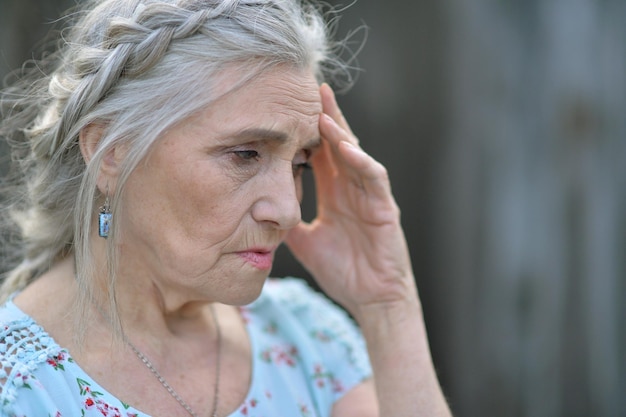 Senior woman near blooming tree