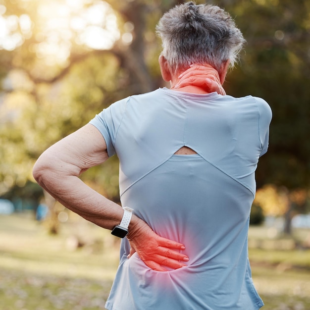 Senior woman neck and back pain red and injury accident from exercise or training on an outdoor park Fitness cardio and female with muscle sprain hurt spine or medical emergency after workout