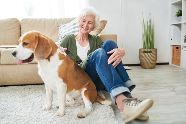 Senior woman playing with her dog