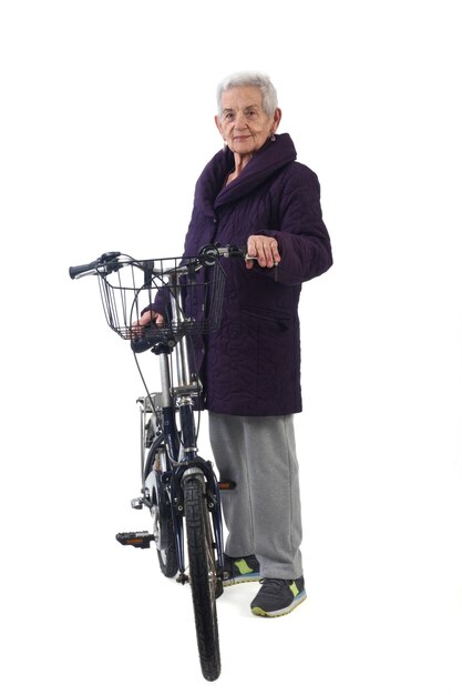 Senior woman posing with a bicycle on white background