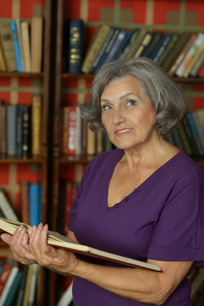 Senior woman reading in library