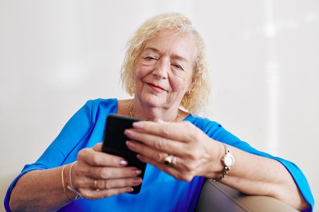 Senior woman reading text message