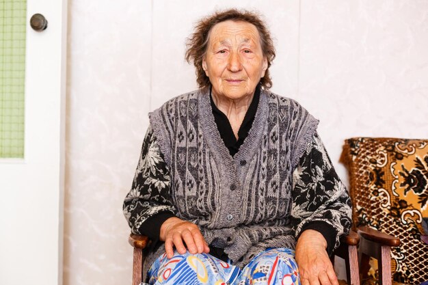 Senior Woman Relaxing In Chair At Home