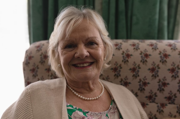 Senior woman relaxing in living room at home