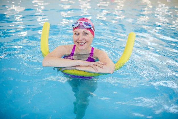 Senior Woman Relaxing in Swimming Pool