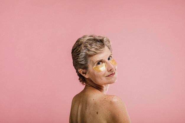 senior woman relaxing with a golden eye mask