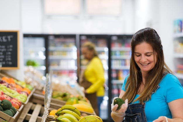 Senior woman selecting fruits and vegetables in market