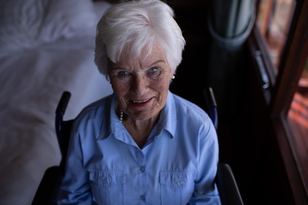 Senior woman sitting on chair at home