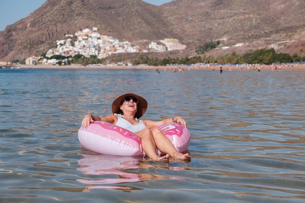 Senior woman sitting on the float on a beach day Concept lifestyle retirement beach