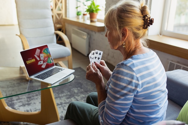 Senior woman studying at home getting online courses