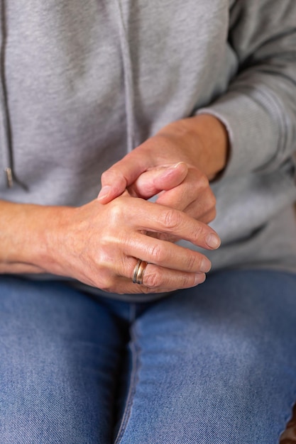 Senior woman suffering from hand and finger joint pain inflammation