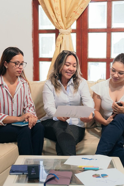 Senior woman talking to small group in office training session