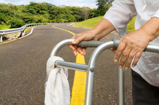 Senior woman using a walker cross road.