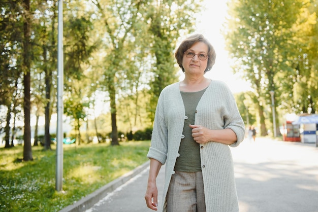 Senior woman walking in the park in summer