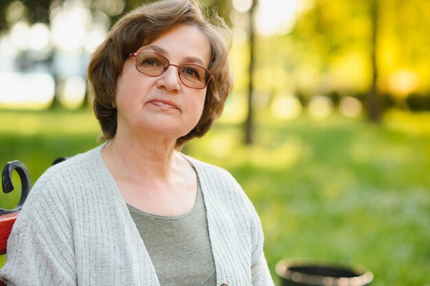 Senior woman walking in the park in summer