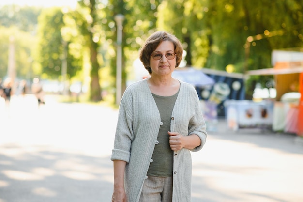 Senior woman walking in the park in summer