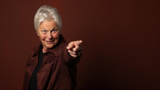 Senior woman wearing casual clothes pointing with hand and finger to the side looking at the camera.