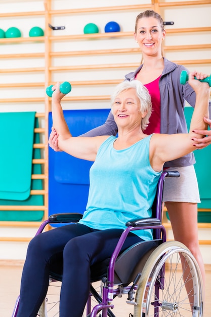 Senior woman in wheel chair doing physical therapy