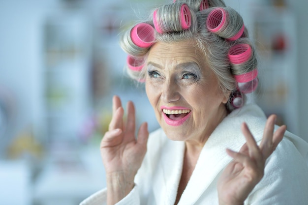 Senior woman in white bathrobe