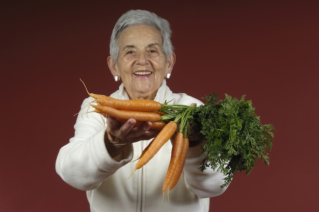 Senior woman with carrots