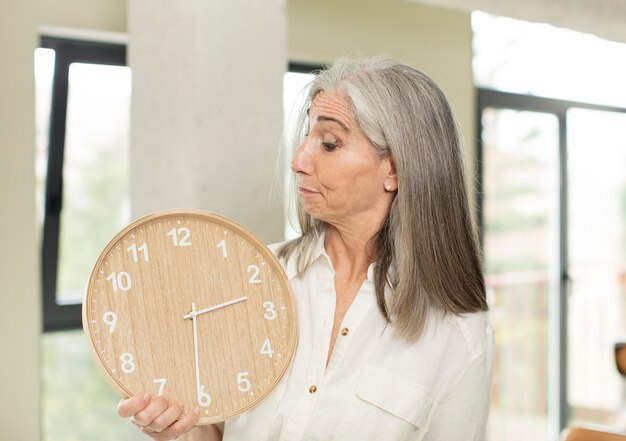 Photo senior woman with a clock
