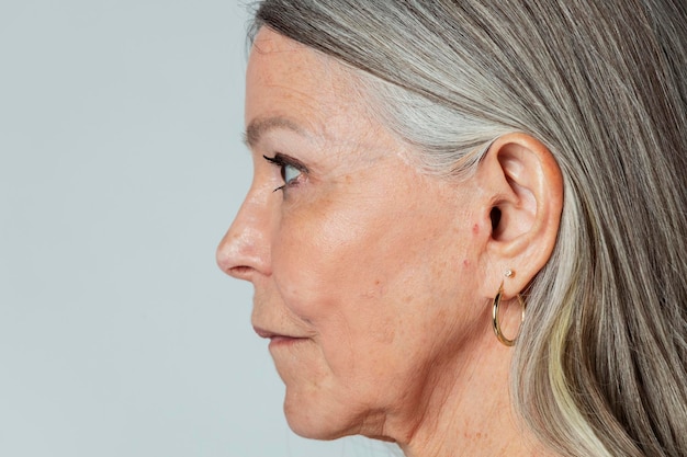 Senior woman with pierced ears in a profile shot