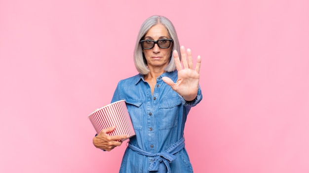 senior woman with pop corns