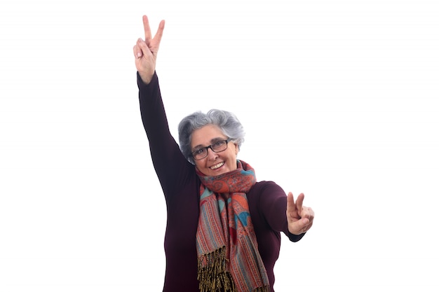 Senior woman with victory sign on white