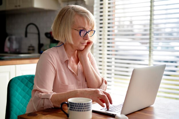 Senior woman working at home