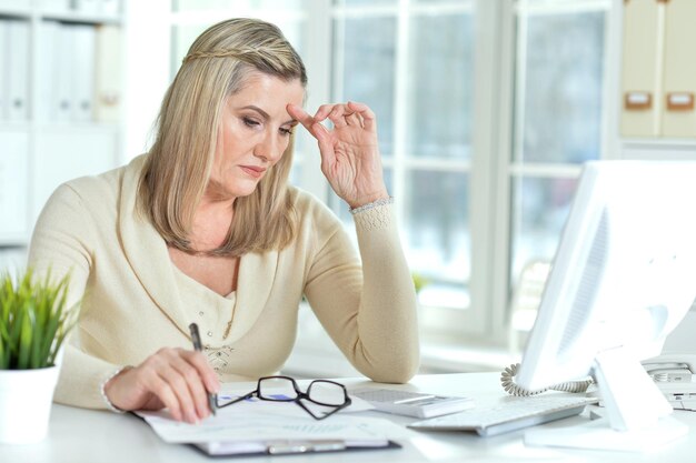 Senior woman working in office