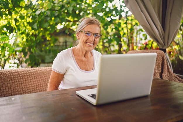 Senior woman working online with laptop