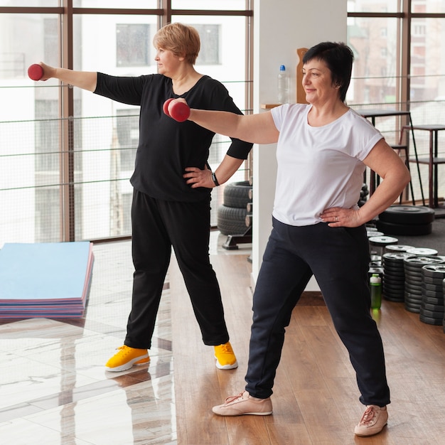 Senior women exercise with weights