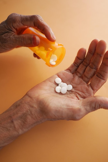 Senior women hand taking pills