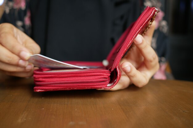 Senior women putting card back in her wallet