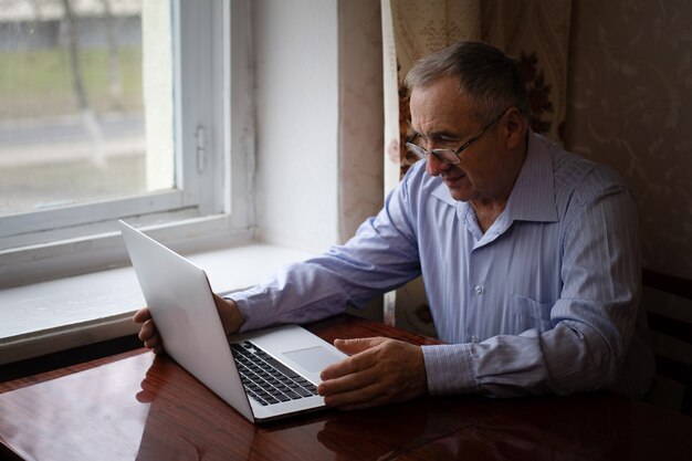 Senior working on a laptop at home