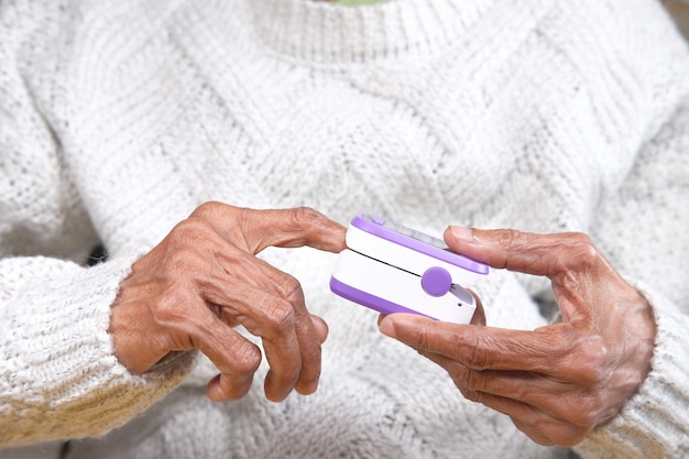 senior young women hand using pulse oximeter