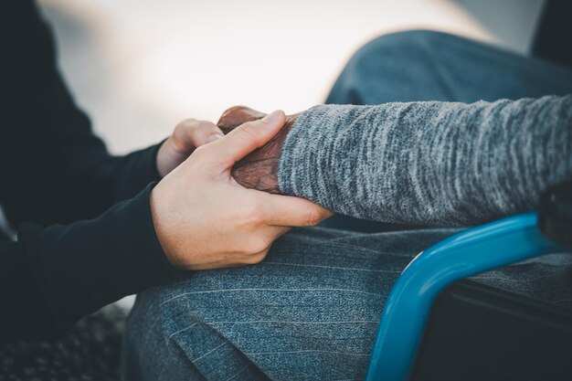 Senior and Young Women Holding Hands Care lovers