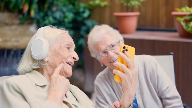 Seniors having fun with the mobile in a nursing home