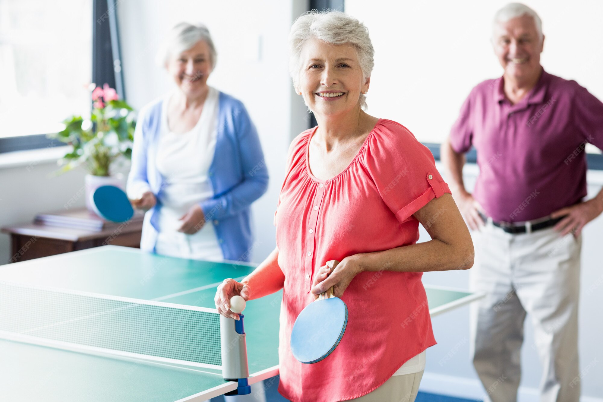 Premium Photo | Seniors playing ping pong