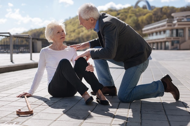 Senor trendy worried lady having ache and waiting for help while good man recommending