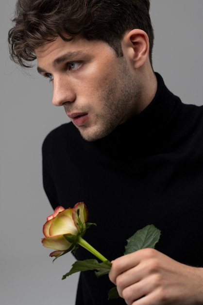 Photo sensitive man holding flower medium shot