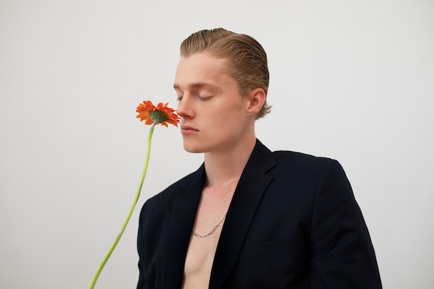 Photo sensitive man holding flower side view