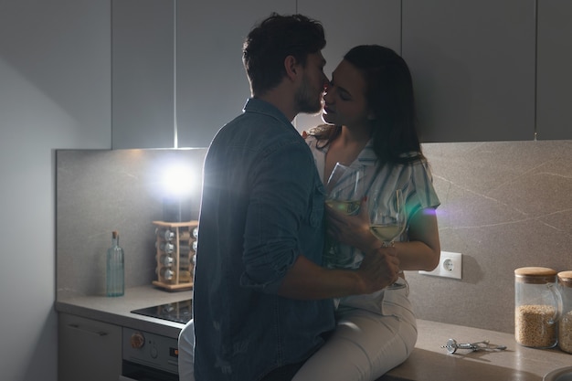 Sensual couple drinking wine and relaxing at home