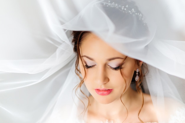 A sensual photo of a girl who has closed her eyes and has a beautiful makeup