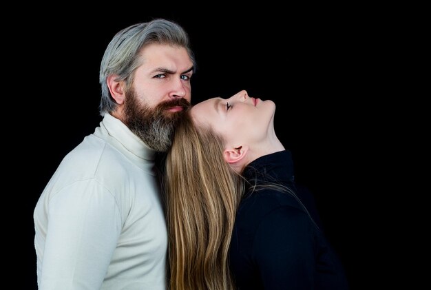 Sensual portrait of fashion couple posing on black background