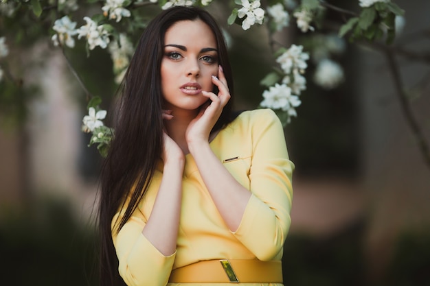 Sensual woman posing in tree flowers