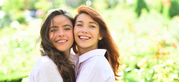 Sensual woman spring outdoor portrait banner happy smiling women talking and laughing in a park with