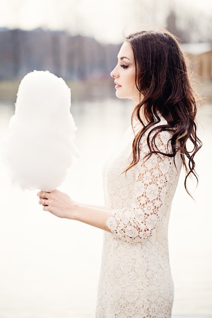 Sensual Woman with Candy Floss. Brunette Fashion Model Outdoors