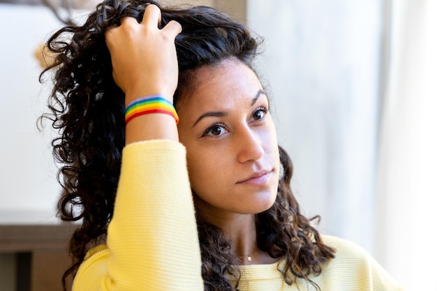 Sensual woman with a rainbow lgbt bracelet in a salon